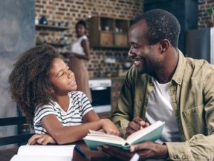 daughter sharing book with father