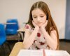 Girl with sad face in empty classroom