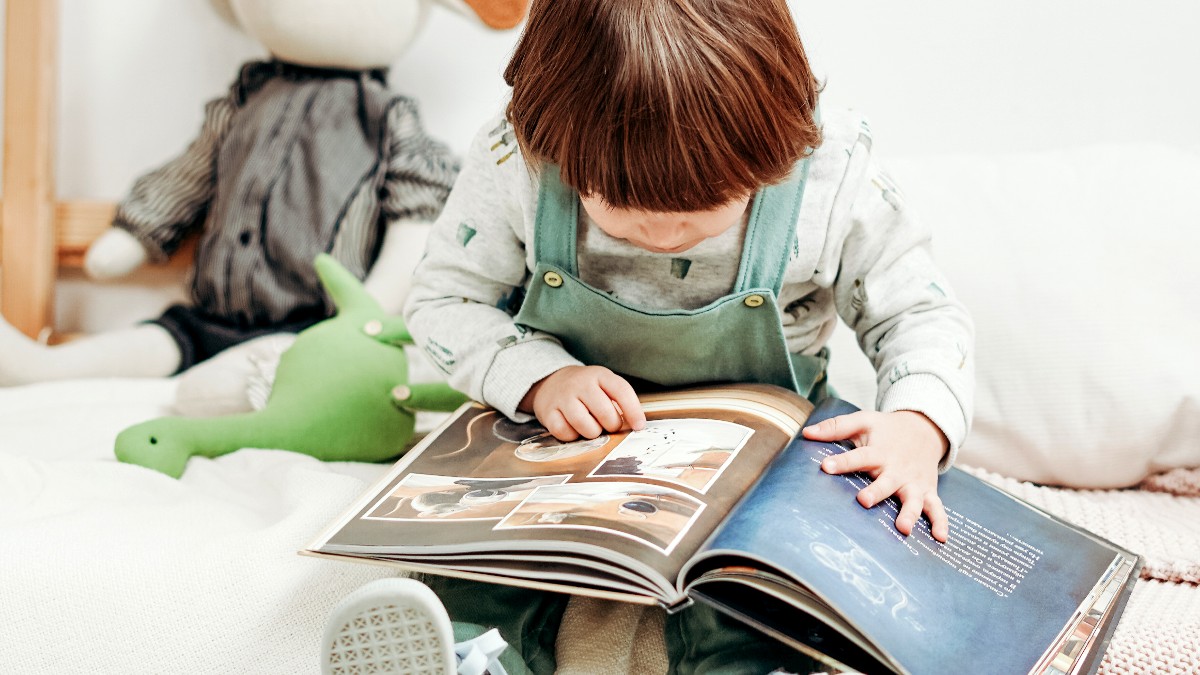 toddler looking at picture book