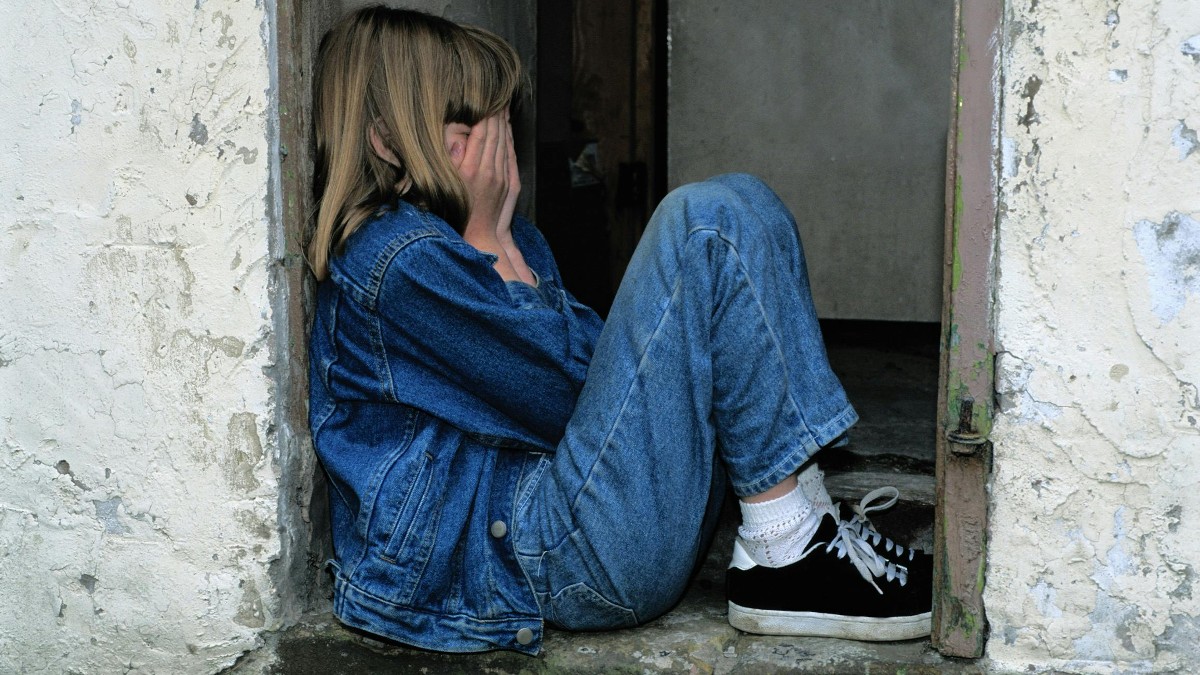 girl sitting in doorway